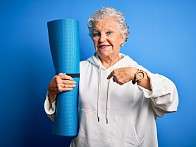 Senior woman with Pilates mat